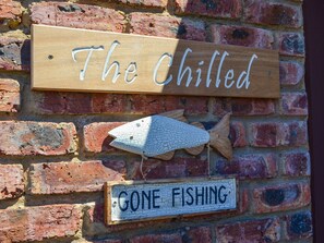 A wooden sign with "The Chilled" and a fish decoration, indicating a fishing theme. - The River House (Colchester)