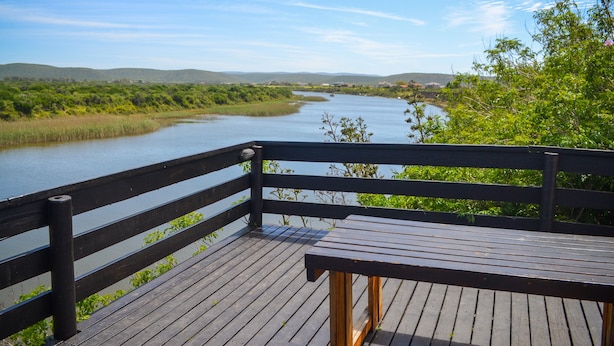 A wooden deck overlooking a river with a view of distant hills. - Addo Park View - Sundaze Riverside (Colchester)