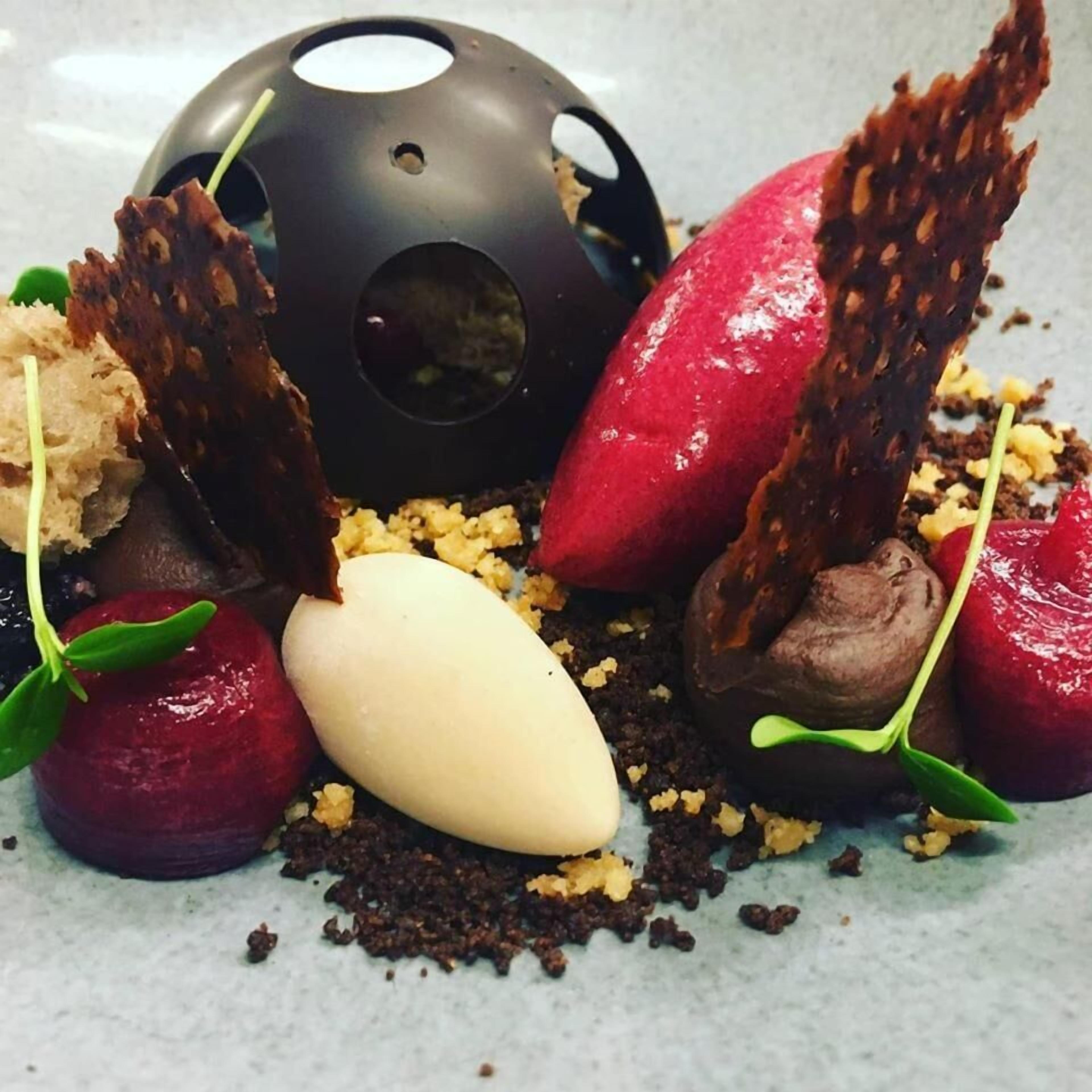 A dessert plate with various chocolate and fruit items.