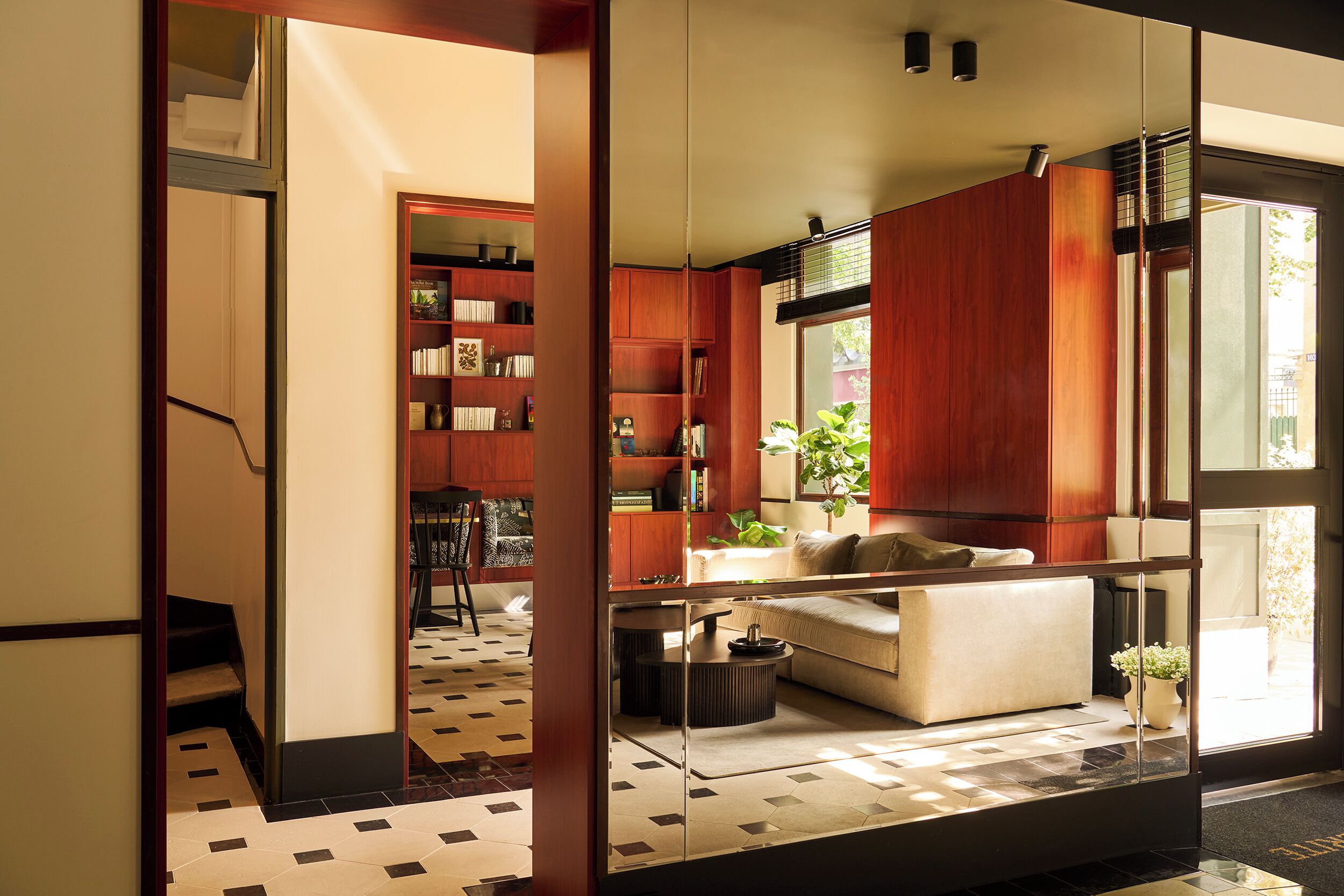 A modern interior with a sofa, a coffee table, and a bookshelf.