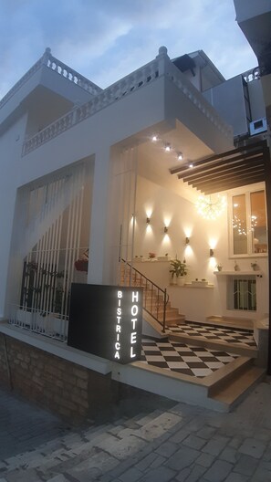 A hotel entrance with a checkered floor, a staircase, and a sign that reads "BISTICA HOTEL". - Bistrica Hotel (Sarandë)
