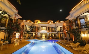 Relax by the pool surrounded by balconies and terraces at NISH CARIA.