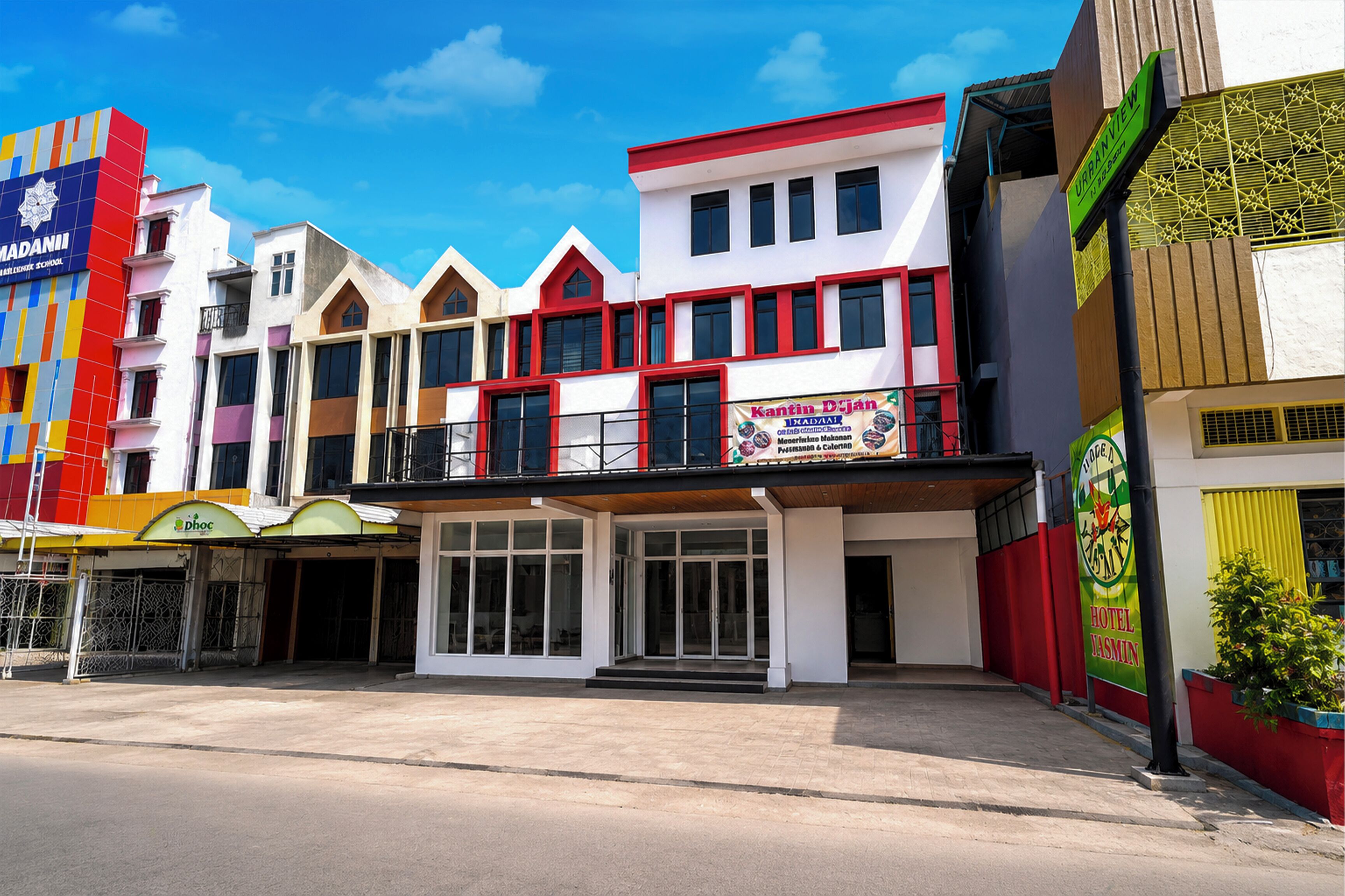 A multi-story building with a ground-level commercial space featuring a sign for 'Kantin Djan.'