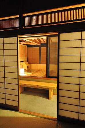 A traditional Japanese room with tatami flooring, a low wooden table, and sliding shoji doors. - Kusatsu Onsen Yuyado Iwafuji (Kusatsu)