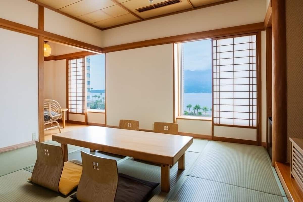 A traditional Japanese-style room with tatami flooring, a low table, and sliding doors.
