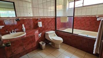 A bathroom with a sink, toilet, and bathtub.
