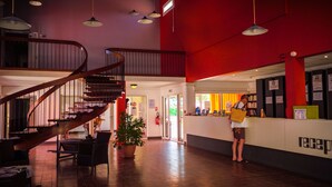 A spacious lobby with a wooden staircase, a reception desk, and a potted plant. - Vacances passion - Village La Bayette (Le Pradet)