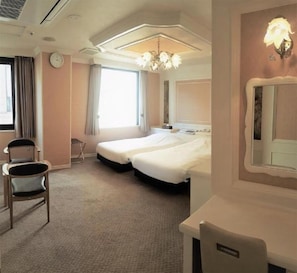 A hotel room with two beds, a desk, a chair, a chandelier, a clock, and a window with curtains. - Royal Hotel Shinokubo (Tokyo)