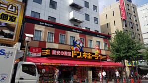 A hotel named Don Quijote with a red awning and a large cartoon character sign. - Royal Hotel Shinokubo (Tokyo)