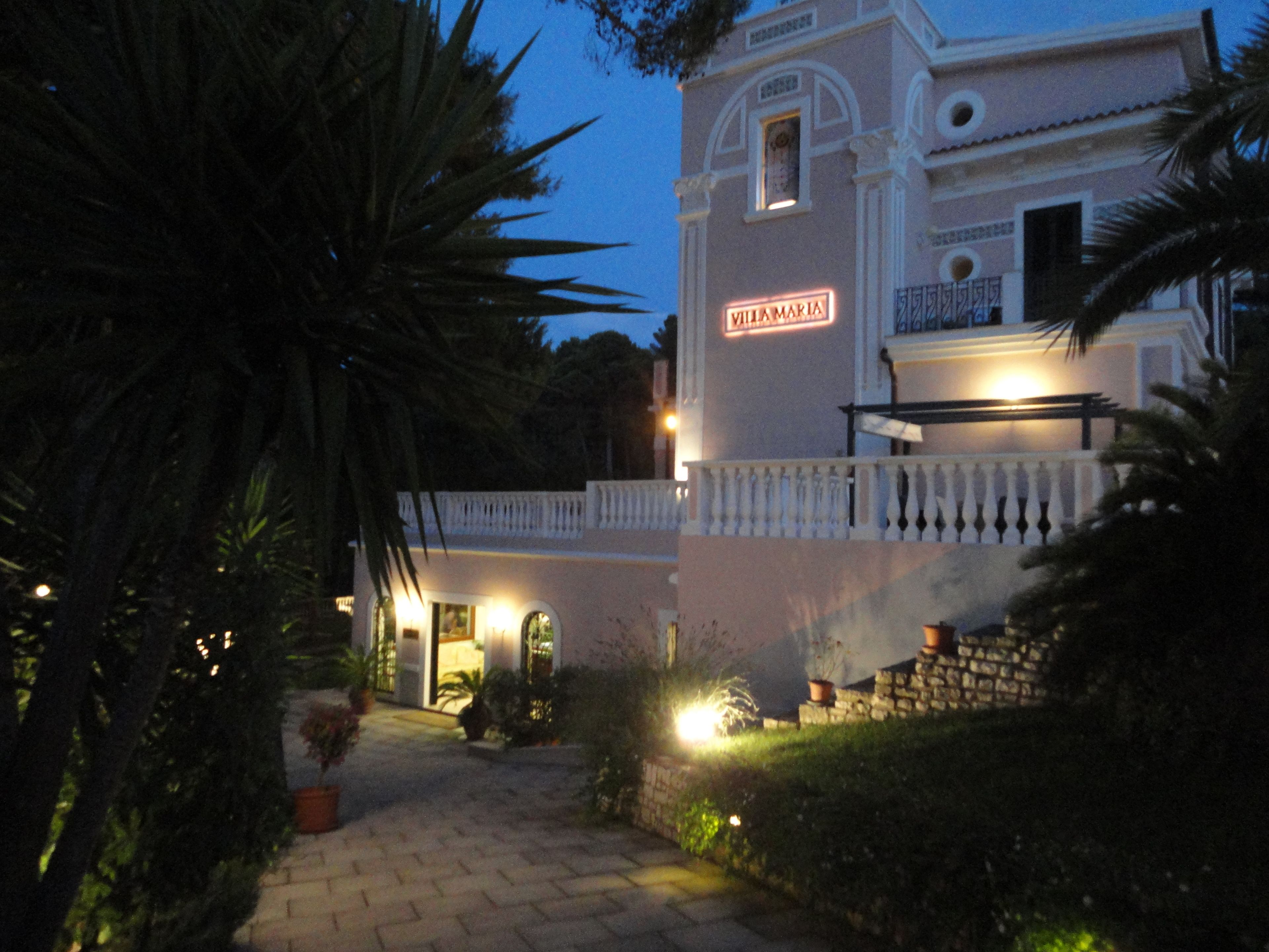 Un edificio con un letrero que dice "VILLA MARIA" de noche.