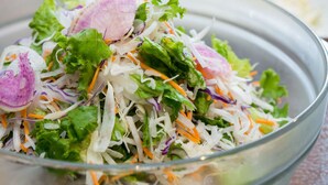 A bowl of salad with various vegetables.