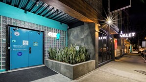 A building with a blue door labeled 'easy living' and a 'Valet' service sign.