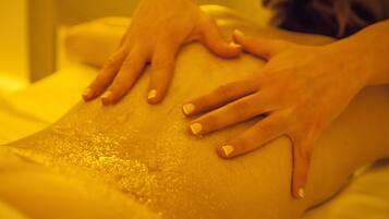 A close-up of hands performing a massage on a person's back.
