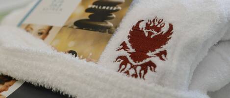 A white towel with a red emblem and a tag.