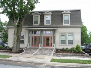 A two-story house with a front porch, a garage, and a driveway.