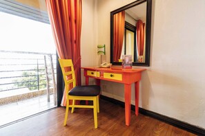 A room with a desk, chair, and a window with curtains. - Reddoorz Plus @ The Ridge Tagaytay City (Tagaytay)