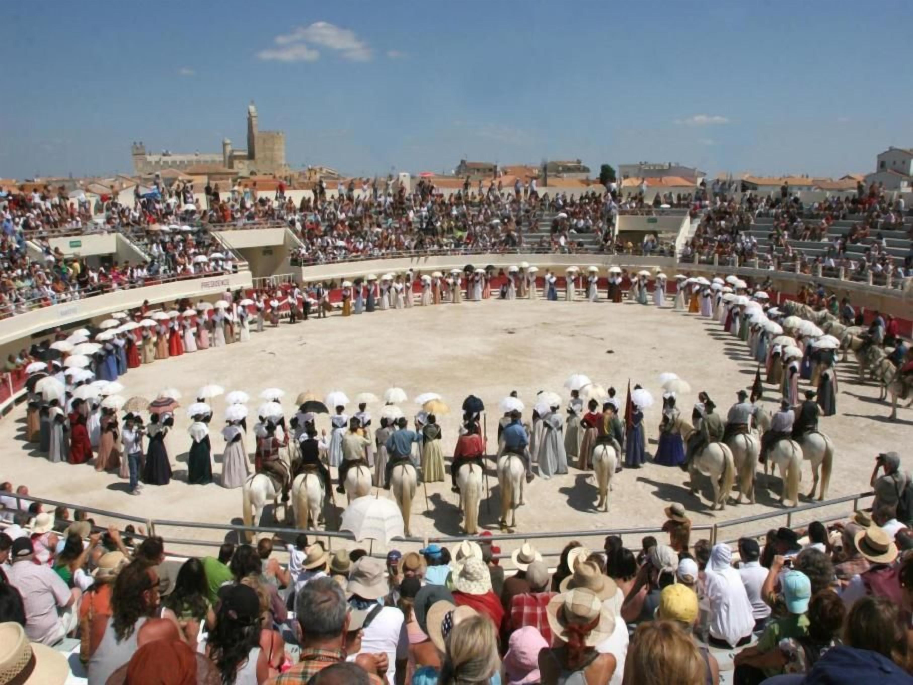 A large outdoor amphitheater with tiered seating filled with spectators.