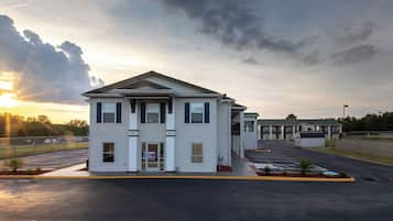A two-story building with a flat roof and a central entrance.