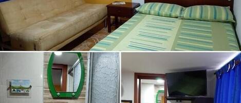 Un dormitorio con una cama, un sofá, una mesita de noche y dos cuadros en la pared.