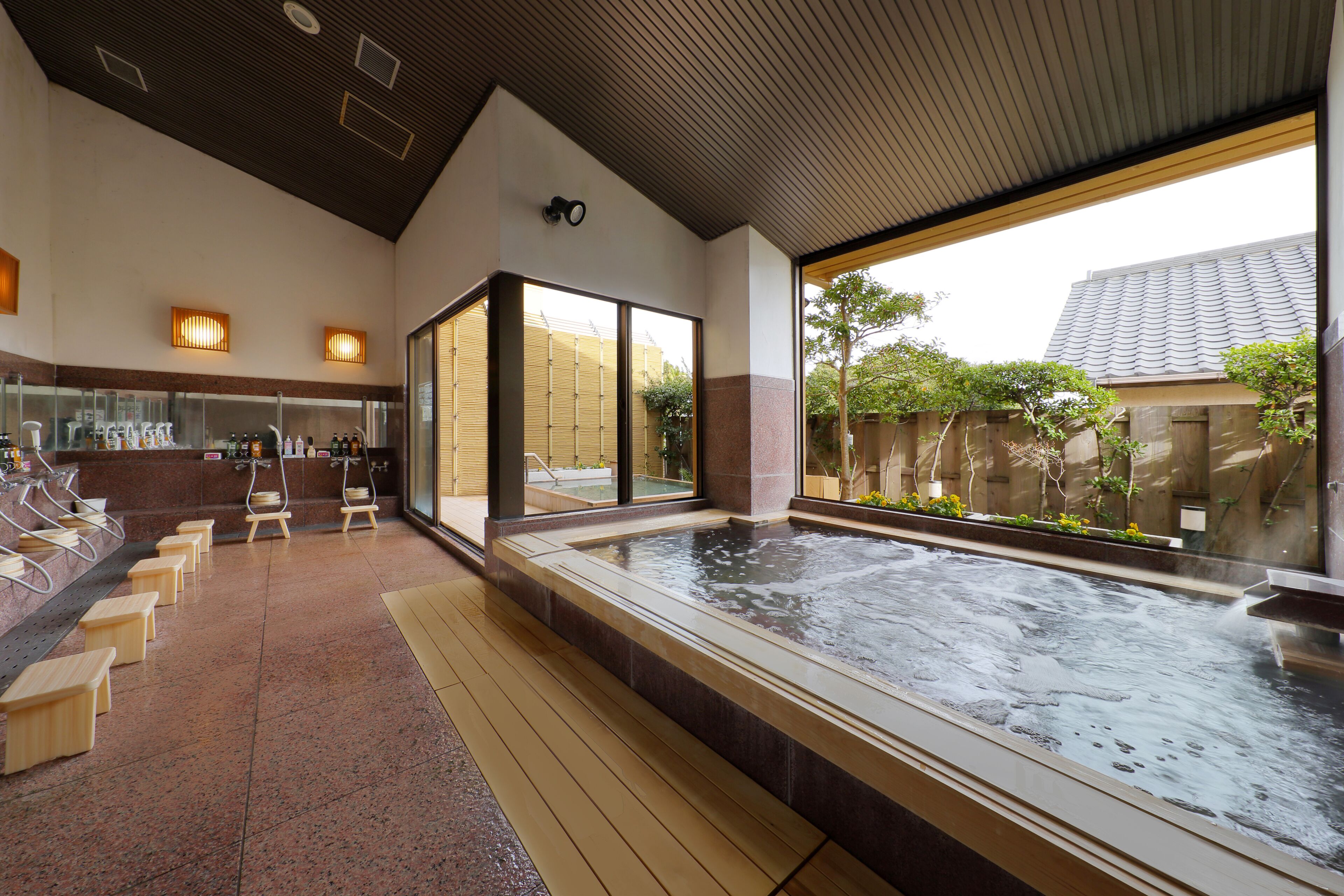 A spa area with a hot tub, seating, and a reception desk.