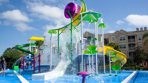 A water park with multiple slides and water features, surrounded by buildings. - Luxury Villa  2 miles from Disney  (Kissimmee)
