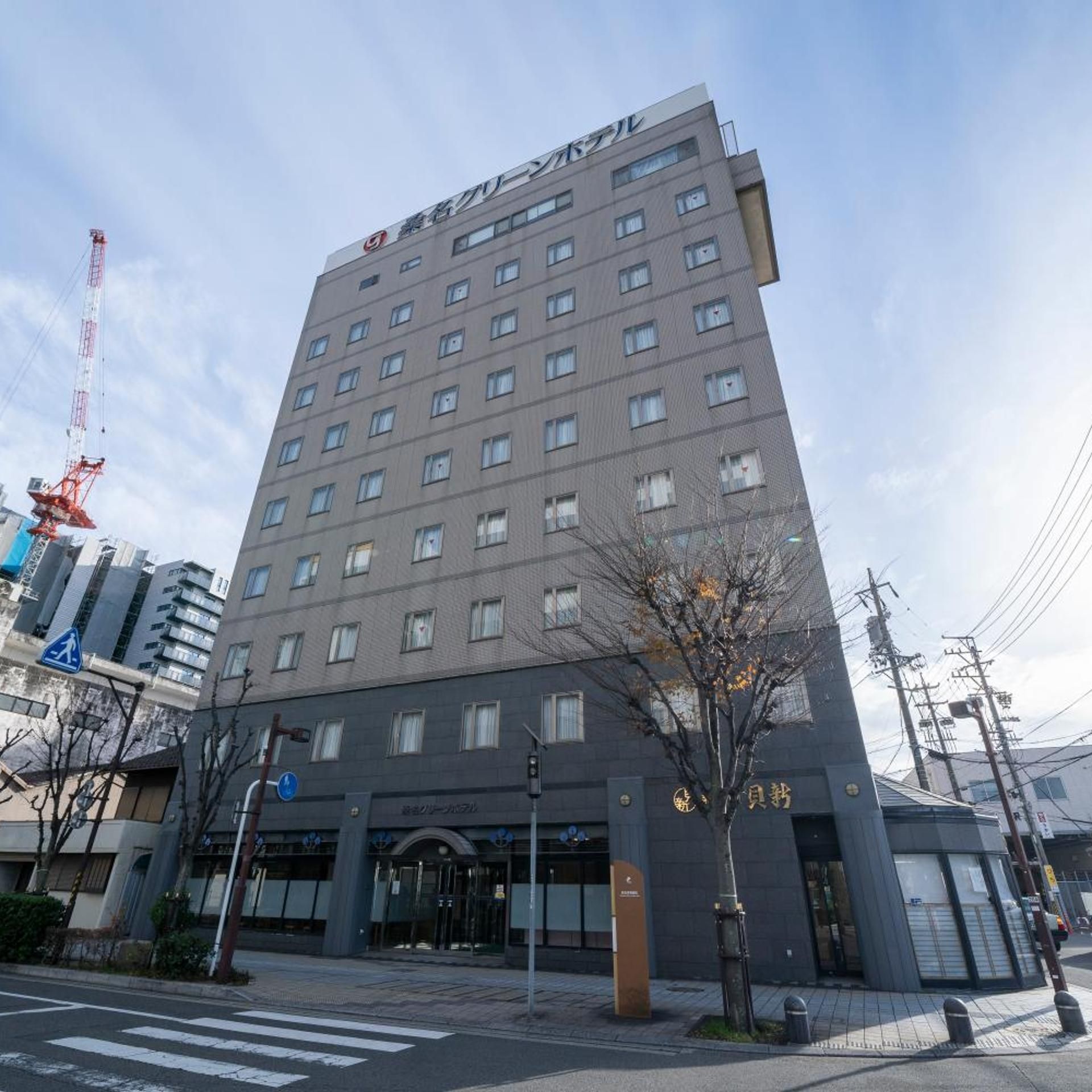 A multi-story hotel building with a modern architectural design, featuring a prominent entrance and a visible signboard.