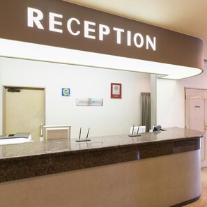 A reception desk with a 'RECEPTION' sign above it. - Kuwana Green Hotel (Kuwana)