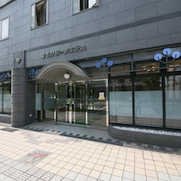 A building entrance with a glass door and a sign above it.