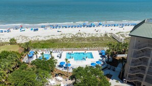 A resort with a pool area, beach access, and a building with balconies. - 3133 Villamare - Direct Oceanfront Views! (Hilton Head)