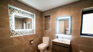 A modern bathroom with a toilet, sink, and mirror. - New Modern Build on Muckross Road, Killarney, Kerry (Killarney)