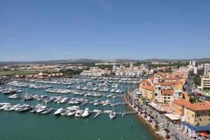 Stroll along the waterfront, surrounded by a marina filled with boats and a mix of traditional and modern architecture.