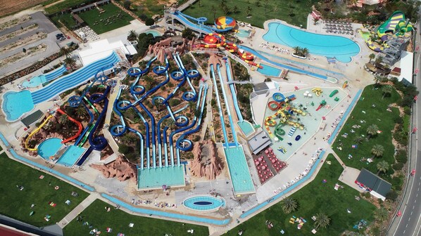 An aerial view of a water park with multiple slides and pools.