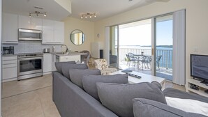 A modern kitchen with a built-in microwave, oven, and a dining area with a table and chairs.