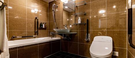A modern bathroom with a bathtub, toilet, and sink.