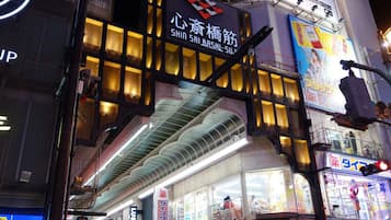 A brightly lit commercial building with illuminated signage and a prominent entrance.