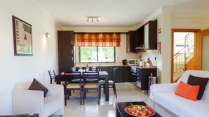 A modern living room with a dining area, kitchen, and staircase. - 2 Bed House, Pera,  Nr. Albufeira, Algarve. - Shared Pool (PERA)