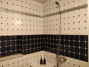 Shower, hair dryer, slippers, towels