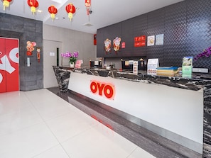 A reception desk with a 'YO' logo, red lanterns, and a 'No Pets Allowed' sign. - Super OYO 977 Hong Kong Suites (Miri)