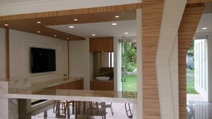A modern kitchen with a large island, built-in appliances, and a view of the outdoors. - Venice Seaview Hotel (Liuqiu)
