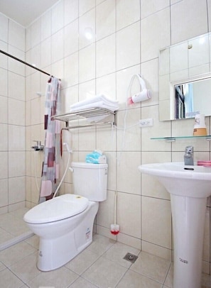 A modern bathroom with a toilet, bidet, and a sink.