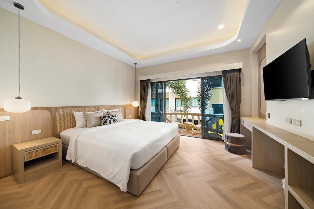 Deluxe Room, 1 King Bed, Balcony, Pool View | 1 bedroom, in-room safe, desk, laptop workspace