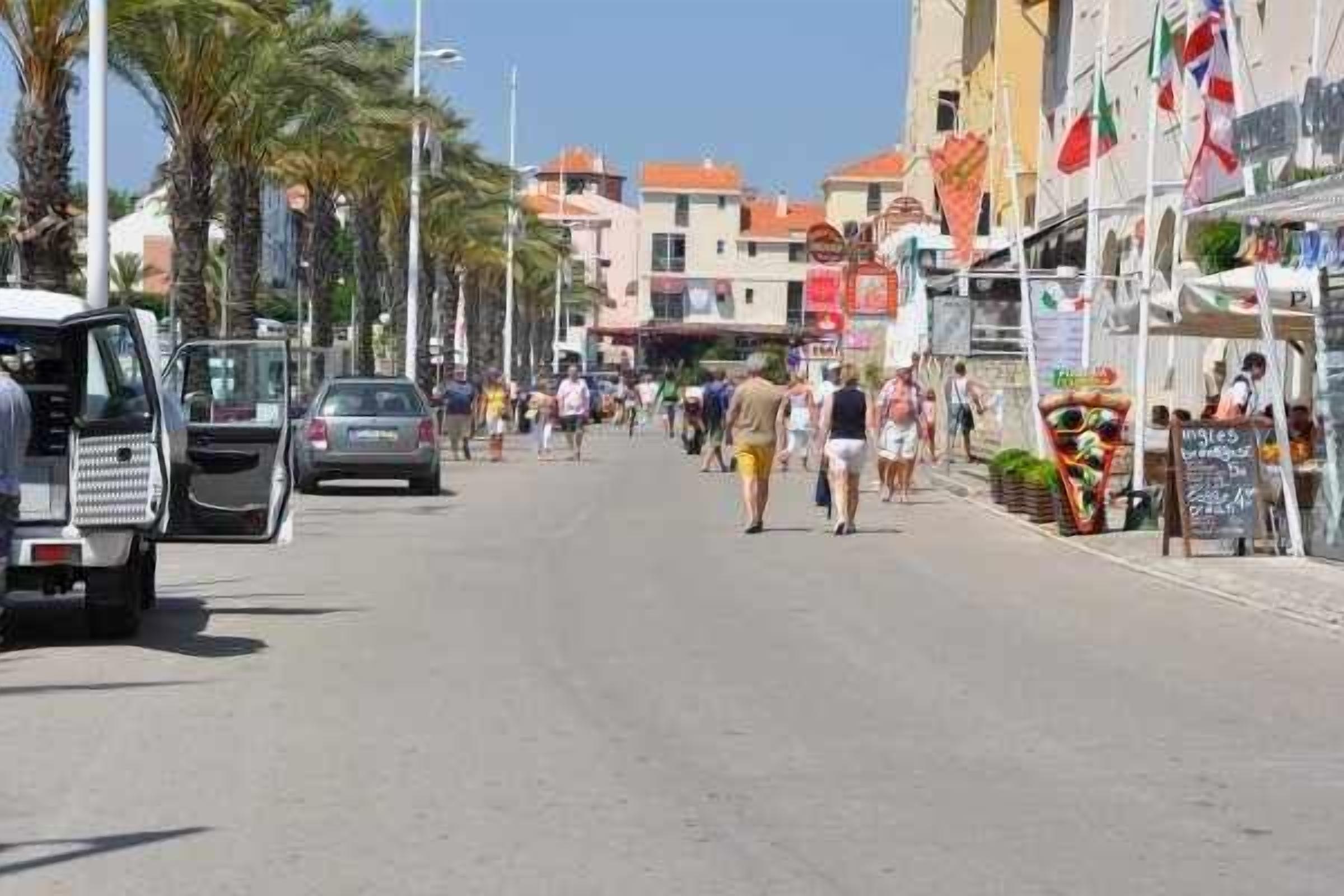 A street with shops and people walking.