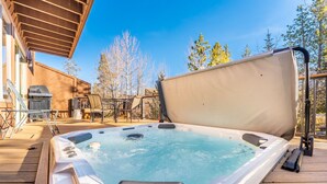 A hot tub on a wooden deck with a covered area and outdoor furniture. - Private Sunken Outdoor Hot Tub, Near 3 Ski Resorts! (Frisco)