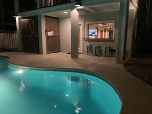 A swimming pool with a covered area, a wooden gate, and a bar area with stools. - 2 Rooftop Decks | Downtown IOP | Pool | Elevator | 1 Blk From Beach | Pets (Isle of Palms)