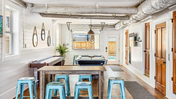 A spacious kitchen with a central island, bar stools, and a view into the dining area. - 2 Rooftop decks, pool/elevator. Downtown IOP, 1 blk from beach. Pet friendly! (Isle of Palms)