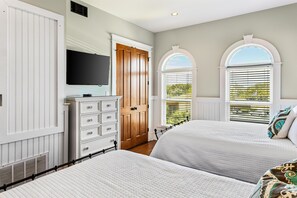 A bedroom with two beds, a dresser, a television, and a window with a view. - 2 Rooftop Decks | Downtown IOP | Pool | Elevator | 1 Blk From Beach | Pets (Isle of Palms)