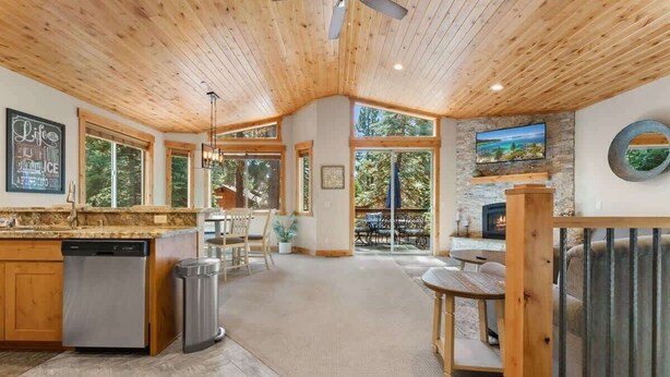 A spacious kitchen with wooden ceiling, large windows, and a stone fireplace. - Deck, Bikes, Newer Build in Upper Kings Beach (Kings Beach)