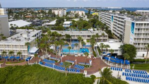 A hotel with multiple floors, a swimming pool, and a view of the sea. - St Pete Beach | Couples Gulf Coast Retreat | Pool + Beach (St. Pete Beach)