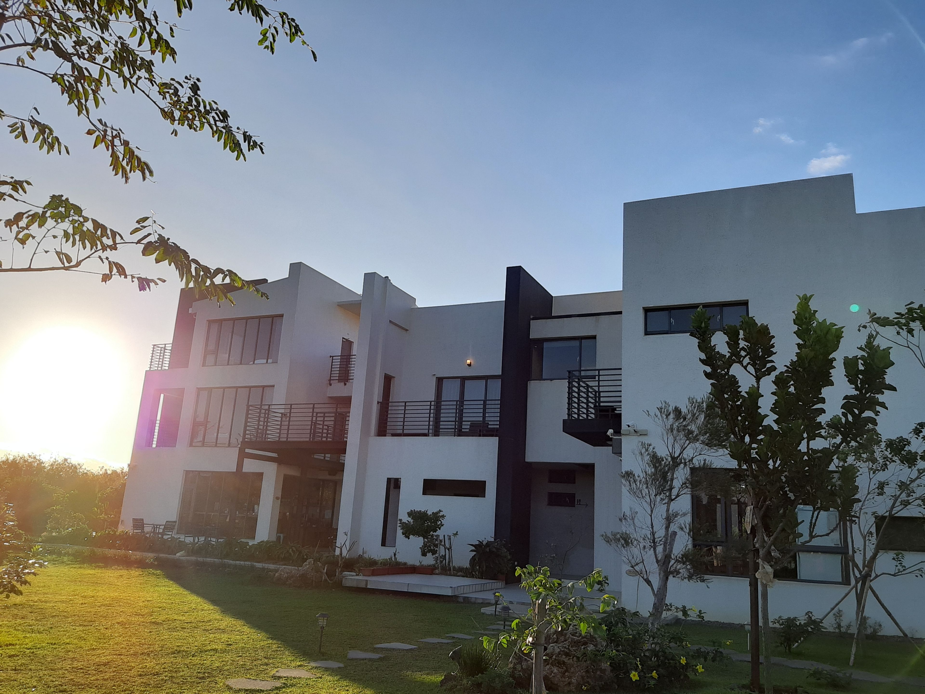 A modern multi-story building with balconies and large windows.