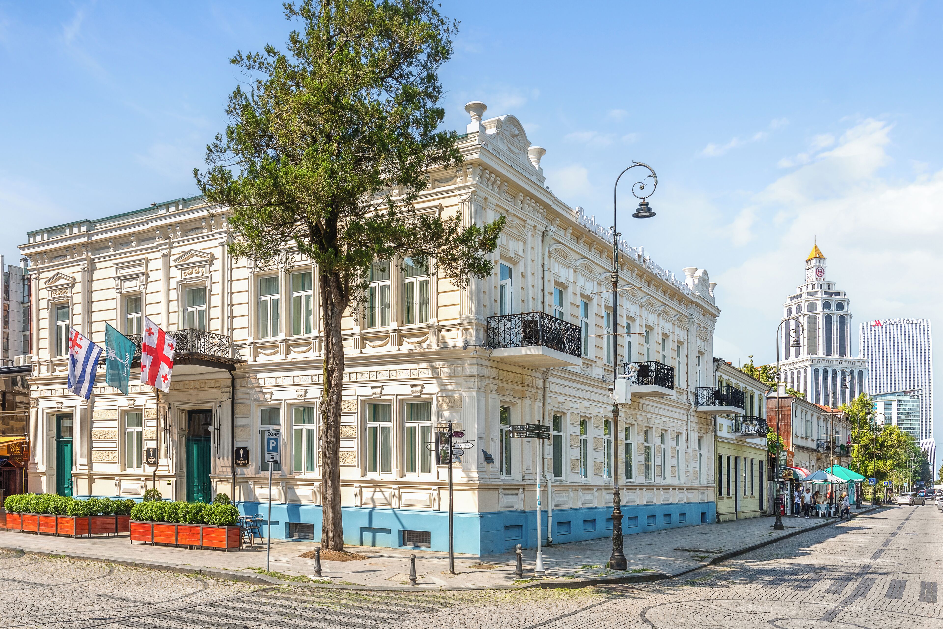 A historic building with a classic architectural style, featuring a prominent entrance and a balcony.